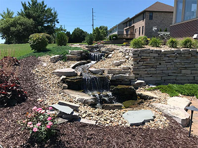 Beautiful water features enhance custom garden landscaping designs at an iowa residence